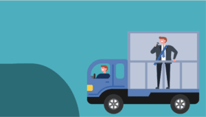 Man being driven around while speaking on a microphone in the bed of a pickup
