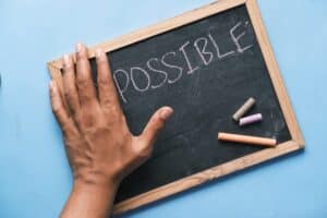 Chalkboard with POSSIBLE written on it