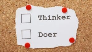 Picture of paper on cork that says Thinker/Doer